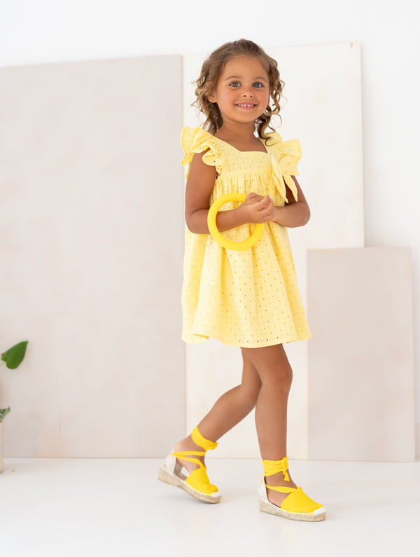 Vibrant yellow Capoeira woven dress for kids, offering a cheerful summer look with lightweight fabric and a fluid silhouette.