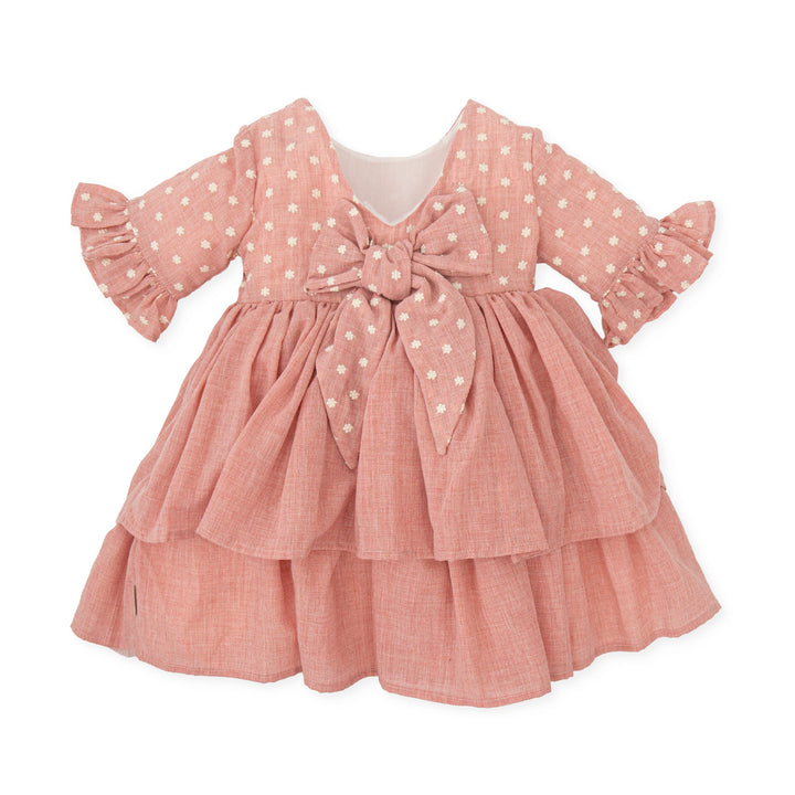 A delicate petal pink woven dress from the Tutto Piccolo baby girl collection, embodying elegance and comfort, ideal for special occasions or stylish everyday wear.