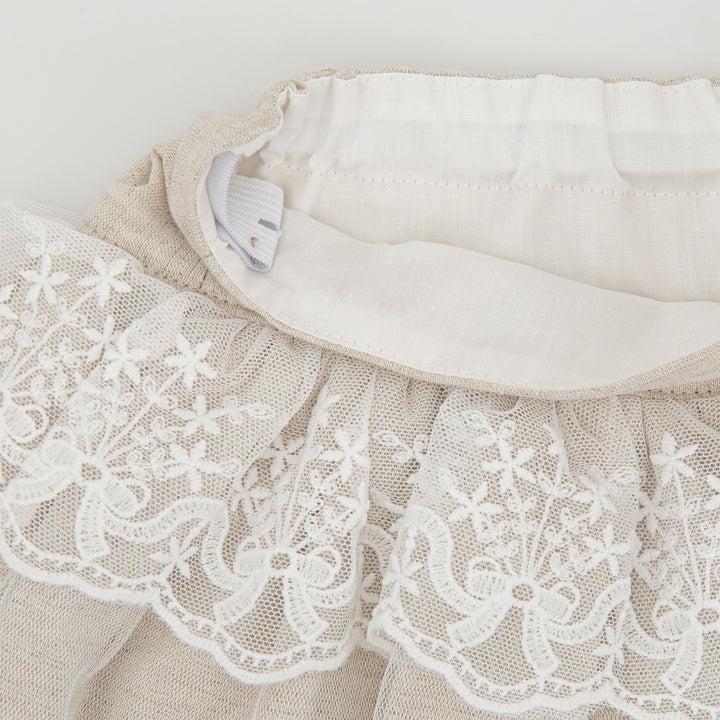Sand-colored Kendo woven skirt for kids, offering a versatile and stylish summer wardrobe option with a relaxed fit.